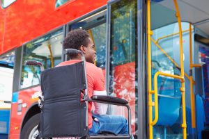 Image: Woman using a wheelchair boarding a bus