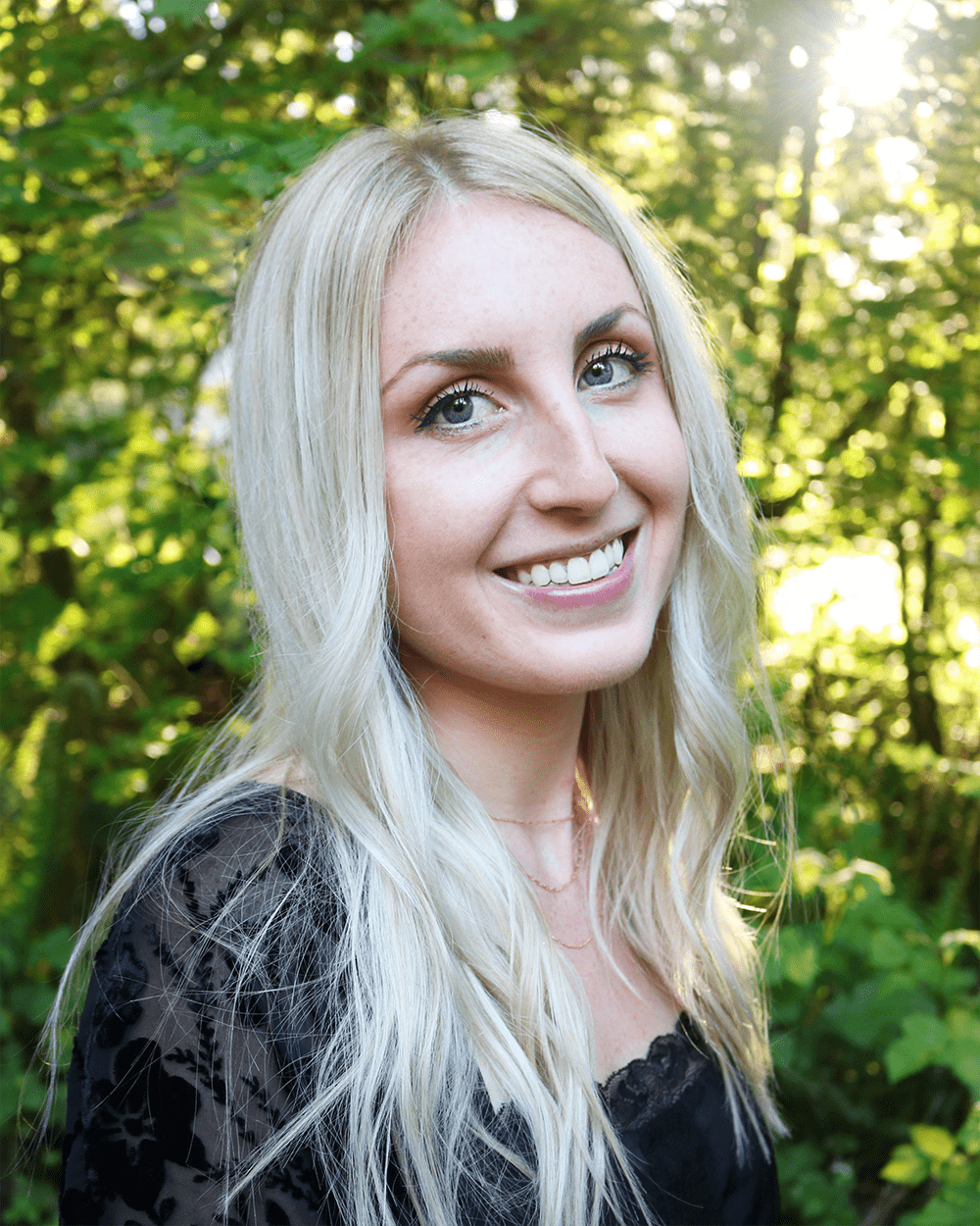 Stefanie_Sm Image: Photo of Stefanie Folkerts, a white woman with straight blonde hair, pink lipstick, blue eyes and a black top, smiling.