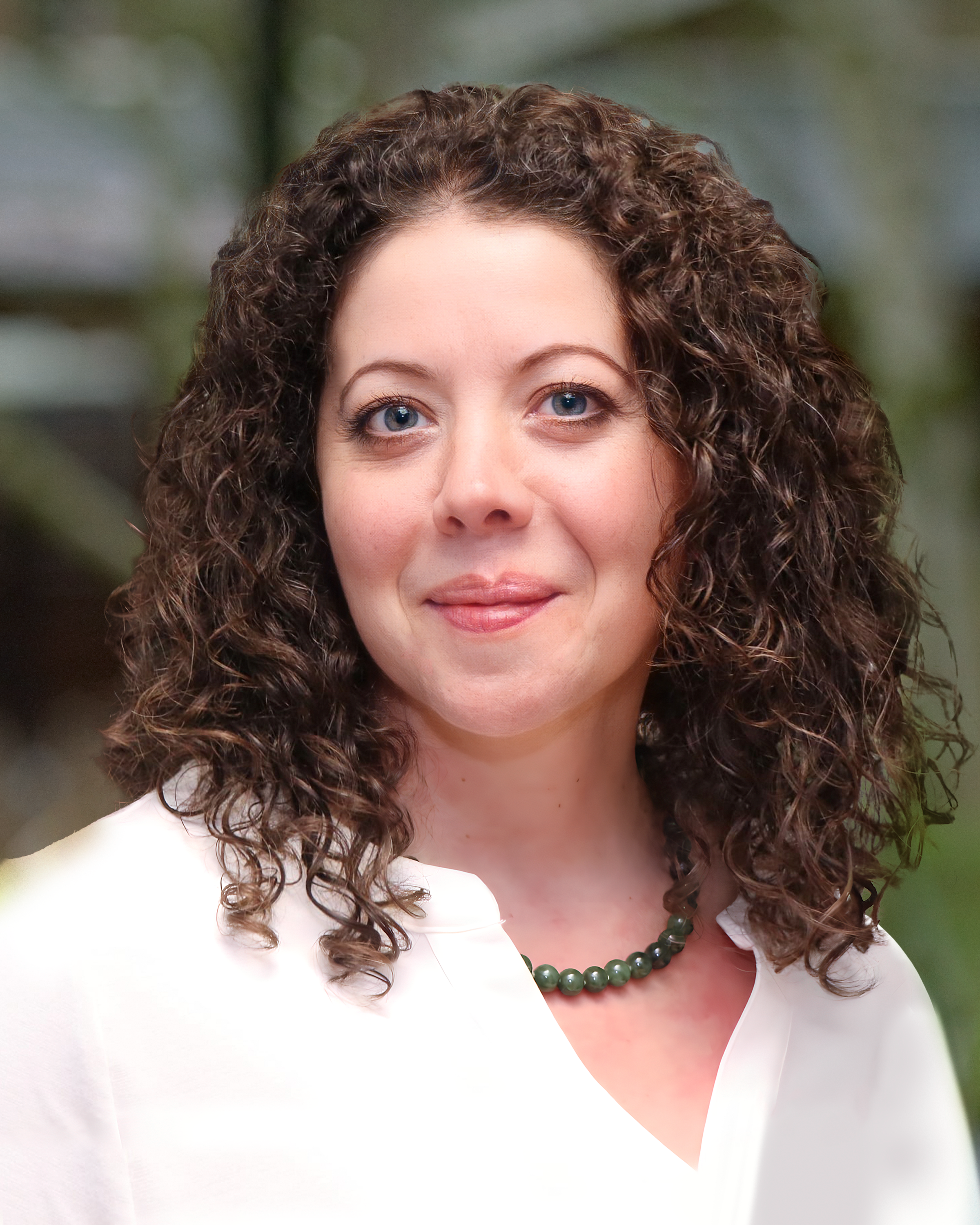 heather Image: Headshot of Heather Evans, a white woman with curly, brown, shoulder length hair & blue eyes, wearing a white button down shirt and a necklace.