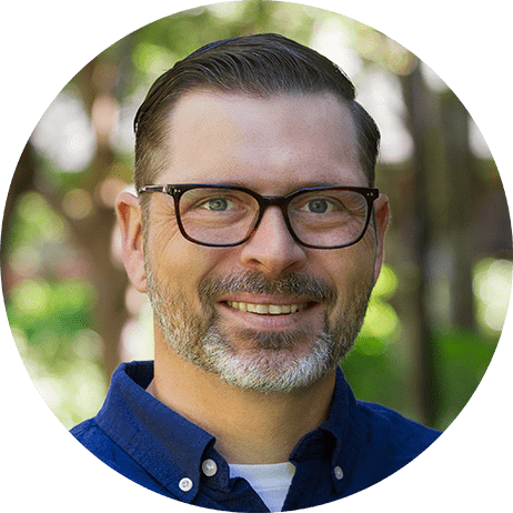 Photograph: Headshot of Dan Rutten, a white man with dark brown hair, glasses, and short beard.