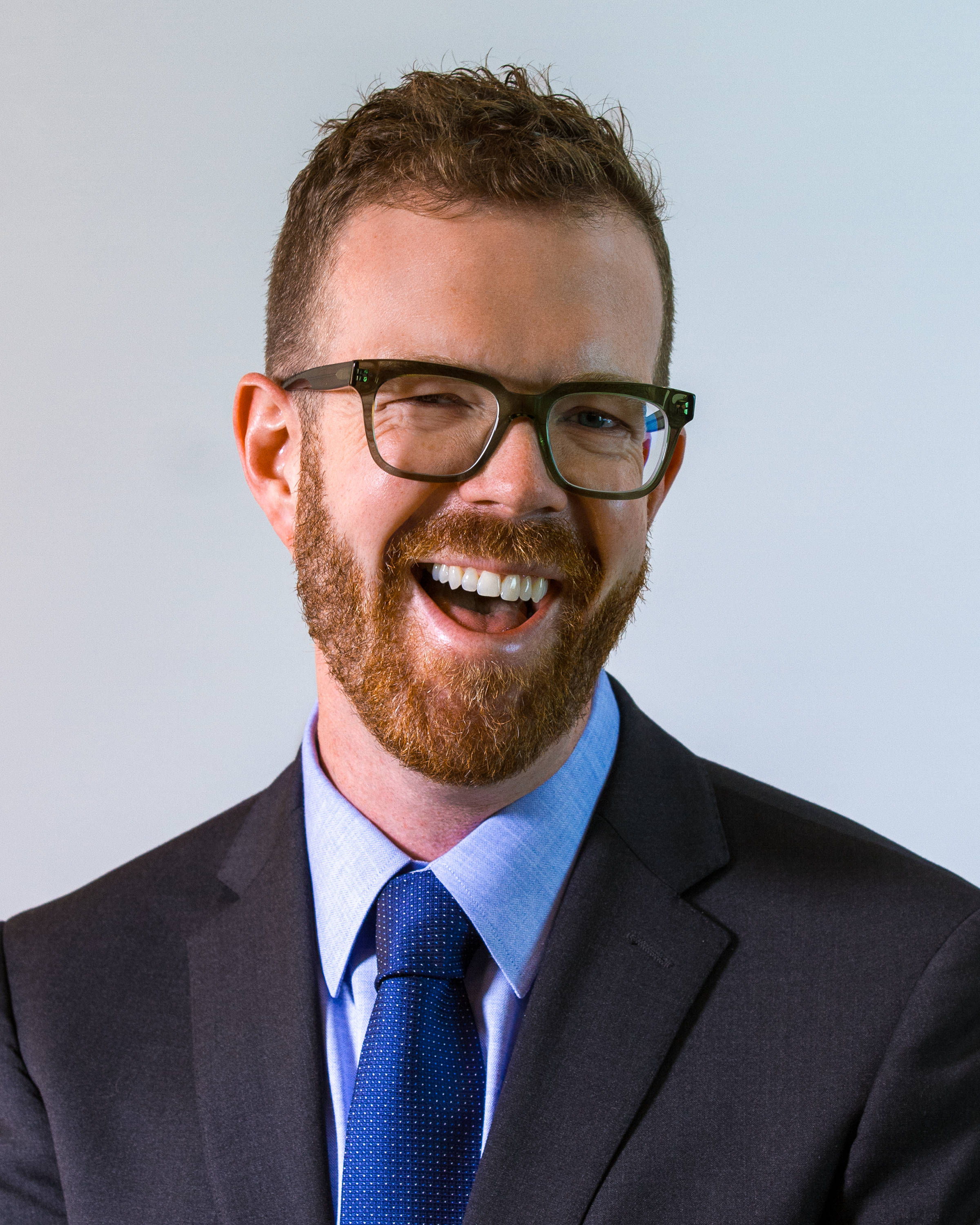 Image: Andrew Coltrin, white male with graying hair and glasses, smiling in his home office.